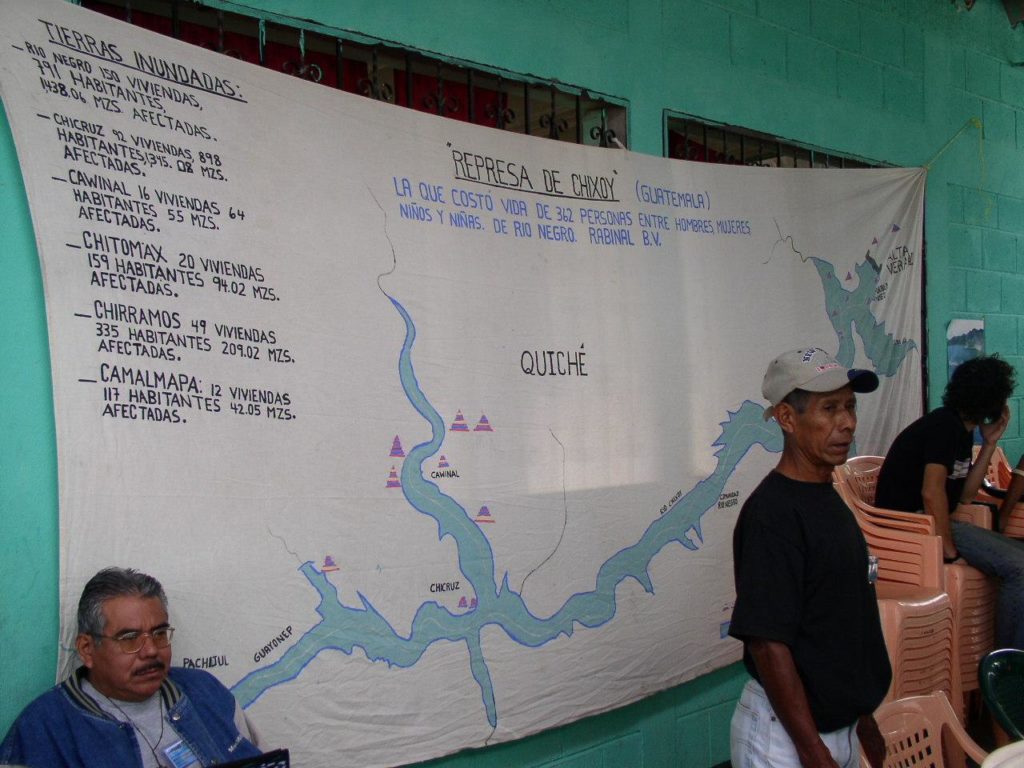 A map of a river with two men standing in front of it.