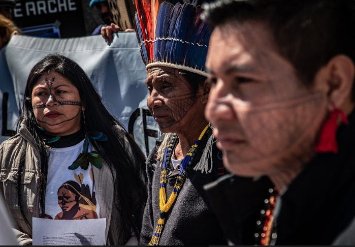 Three Munduruku leaders standing together at a protest.