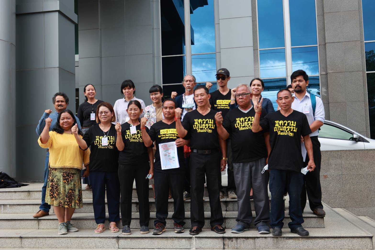 Members of the Thai Mekong People's Network from Eight Provinces stand outside the Thai court after the verdict, Aug. 17, 2022